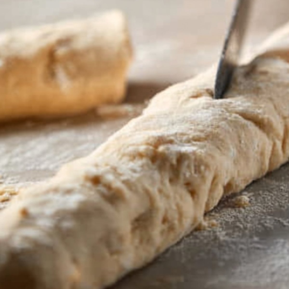 The second image depicts the dough being cut, which might be preparing the dough for individual pieces like rolls or cruffins.